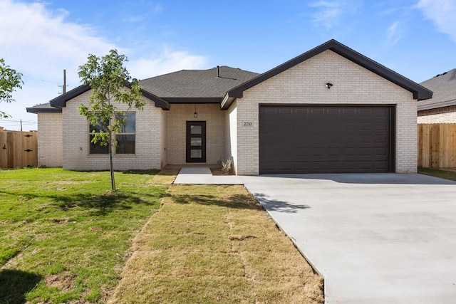 view of front of house with brick siding, an attached garage, fence, and driveway