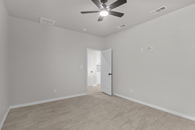 unfurnished room featuring a ceiling fan, baseboards, and visible vents