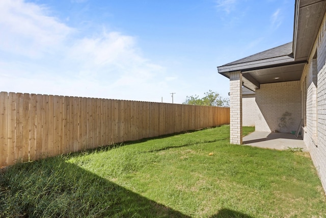 view of yard with a fenced backyard