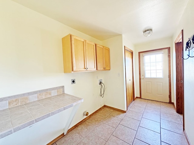 1106 W Eagle Pass, Alpine, TX 79830 - washroom featuring washer hookup, hookup for an electric dryer, cabinet space, baseboards, and light tile patterned flooring