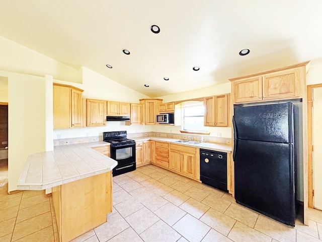 1106 W Eagle Pass, Alpine, TX 79830 - kitchen featuring black appliances, light brown cabinetry, lofted ceiling, under cabinet range hood, and a peninsula