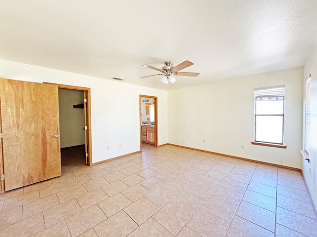 1106 W Eagle Pass, Alpine, TX 79830 - empty room featuring ceiling fan, baseboards, and light tile patterned floors