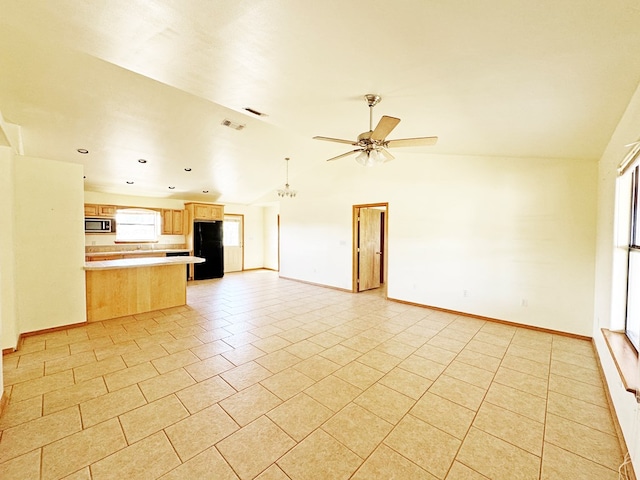 1106 W Eagle Pass, Alpine, TX 79830 - unfurnished living room featuring vaulted ceiling, a ceiling fan, light tile patterned flooring, and baseboards
