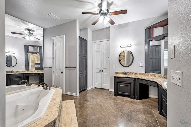 3 E Wavyleaf Ct, Odessa, TX 79762 - full bath with ceiling fan, a closet, a whirlpool tub, vanity, and a textured wall