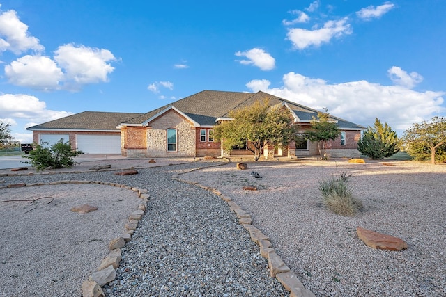 3 E Wavyleaf Ct, Odessa, TX 79762 - view of front of home featuring a garage, brick siding, and concrete driveway