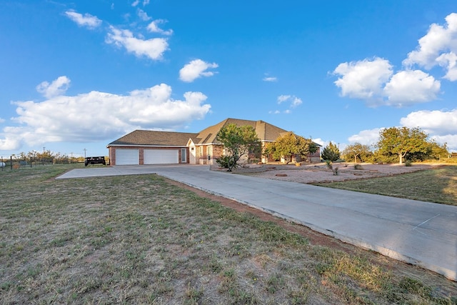 3 E Wavyleaf Ct, Odessa, TX 79762 - view of front of home featuring concrete driveway, a front lawn, a garage, and brick siding