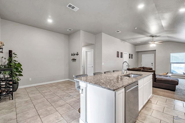 1320 E 94th St, Odessa, TX 79765 - kitchen with dishwasher, light tile patterned floors, open floor plan, vaulted ceiling, and white cabinets