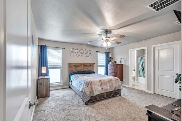 1320 E 94th St, Odessa, TX 79765 - carpeted bedroom featuring multiple windows, a textured ceiling, ensuite bath, and ceiling fan