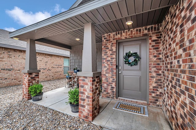 1320 E 94th St, Odessa, TX 79765 - property entrance with brick siding, covered porch, and roof with shingles
