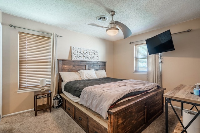 1714 E 53rd St, Odessa, TX 79762 - bedroom featuring light colored carpet, a textured ceiling, and a ceiling fan