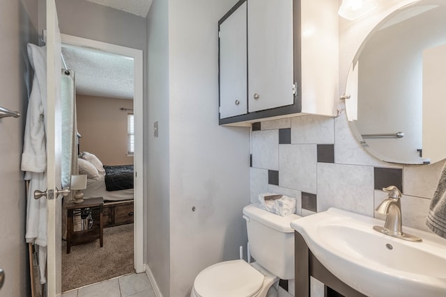 1714 E 53rd St, Odessa, TX 79762 - ensuite bathroom with tile patterned flooring and a textured ceiling