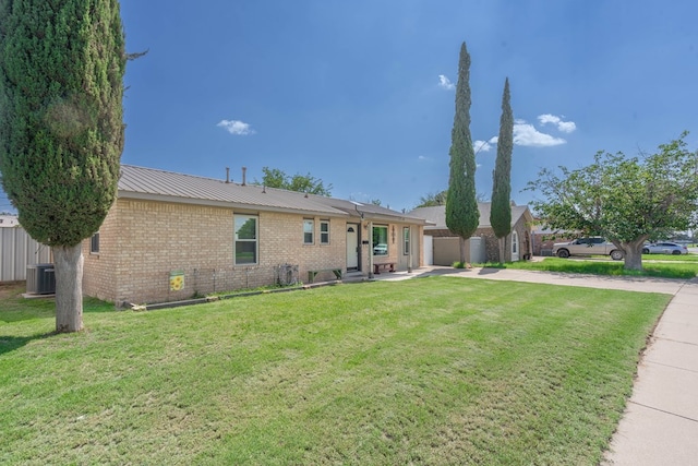 1714 E 53rd St, Odessa, TX 79762 - ranch-style house with concrete driveway, brick siding, a front yard, and a patio area