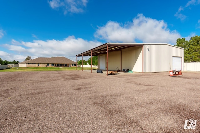 view of parking / parking lot featuring a garage