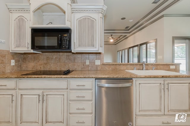 kitchen with black appliances, a sink, crown molding, tasteful backsplash, and cream cabinets