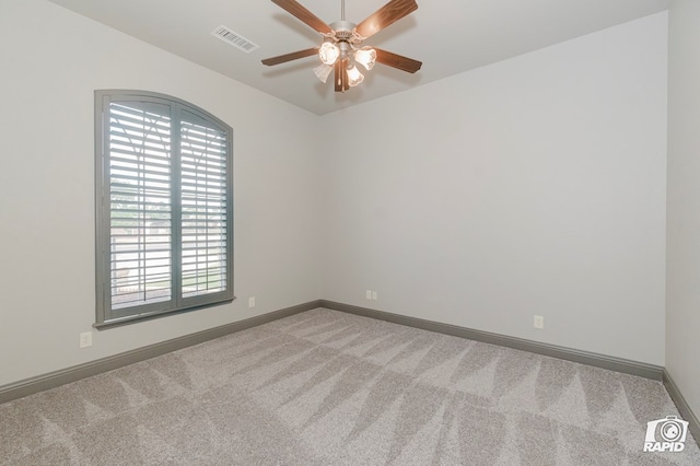 carpeted empty room with ceiling fan, plenty of natural light, and baseboards