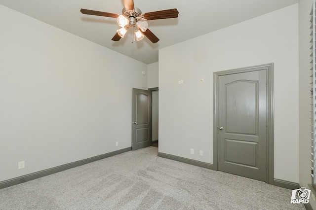 unfurnished bedroom featuring carpet floors, baseboards, and ceiling fan