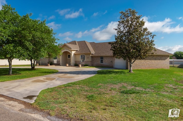view of front of house with curved driveway, an attached garage, brick siding, and a shingled roof