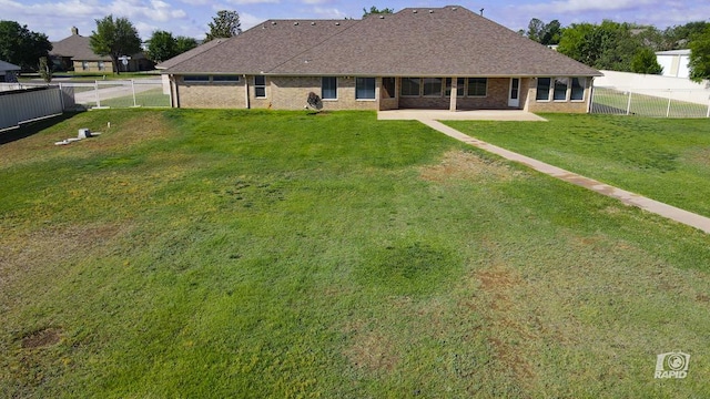 back of property with a patio and brick siding