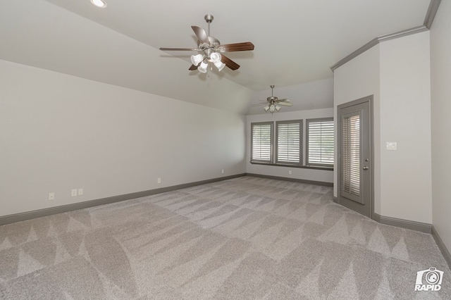 empty room featuring light colored carpet, lofted ceiling, baseboards, and a ceiling fan
