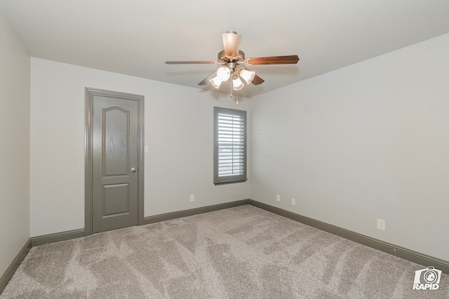 unfurnished room with carpet flooring, ceiling fan, and baseboards