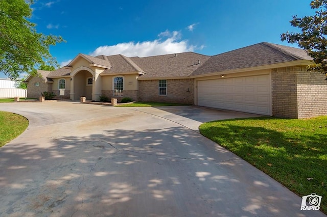 view of front of home with concrete driveway, an attached garage, brick siding, and stucco siding