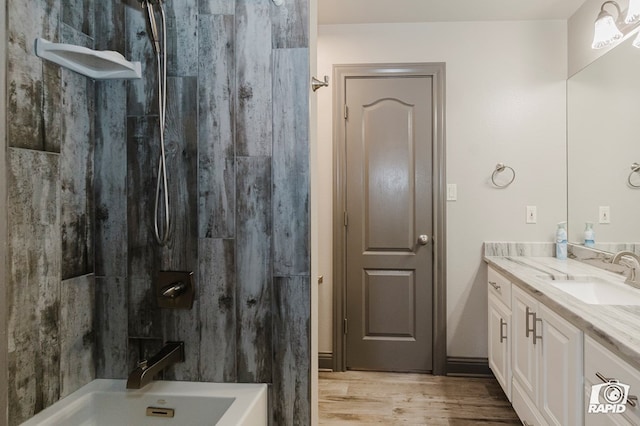 bathroom with a shower, vanity, and wood finished floors