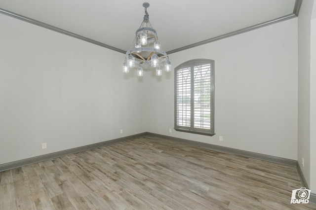 unfurnished room with crown molding, wood finished floors, and baseboards
