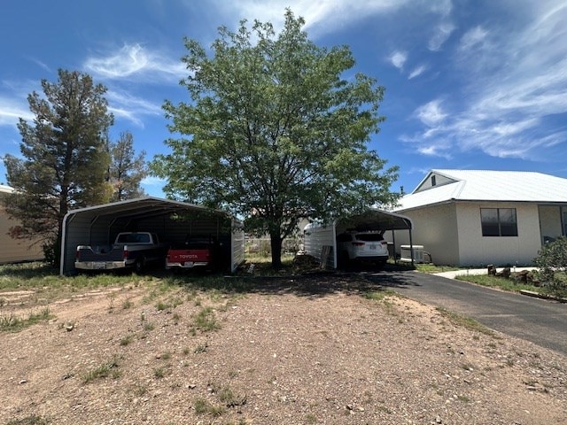 1013 Peachtree Cir, Alpine, TX 79830 - view of front of house with a detached carport and asphalt driveway