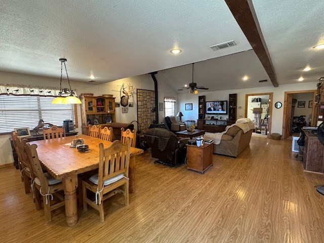 1013 Peachtree Cir, Alpine, TX 79830 - dining space with light wood finished floors, a ceiling fan, a textured ceiling, recessed lighting, and beam ceiling