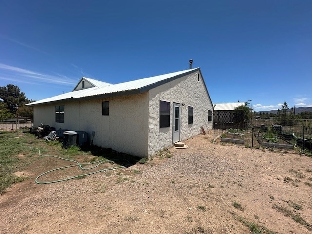 1013 Peachtree Cir, Alpine, TX 79830 - view of side of property featuring a vegetable garden and stucco siding