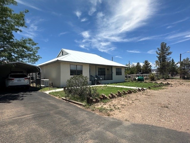 1013 Peachtree Cir, Alpine, TX 79830 - view of front of property featuring a detached carport, stucco siding, and driveway