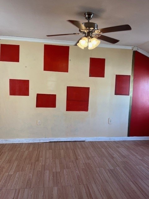 unfurnished room featuring ceiling fan, hardwood / wood-style floors, and ornamental molding