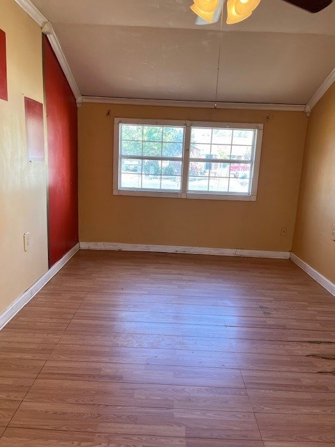 spare room with ceiling fan, light hardwood / wood-style floors, and ornamental molding