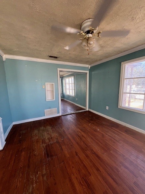 unfurnished bedroom featuring wood-type flooring, a textured ceiling, ceiling fan, and crown molding