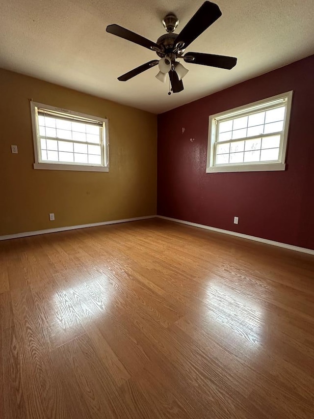 unfurnished room with ceiling fan and light hardwood / wood-style flooring