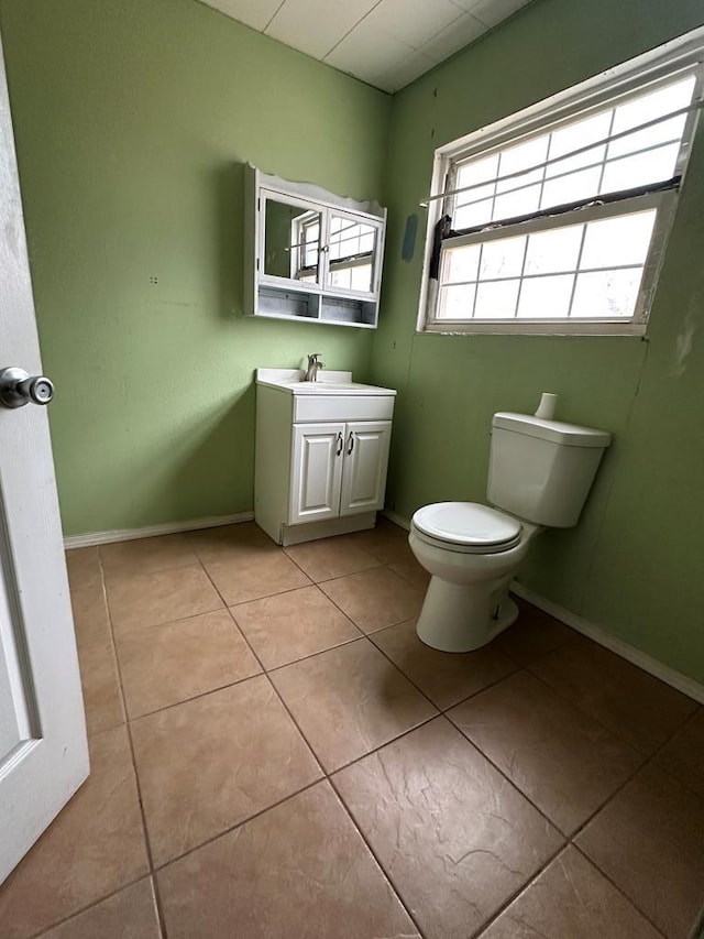 bathroom featuring tile patterned flooring, vanity, and toilet