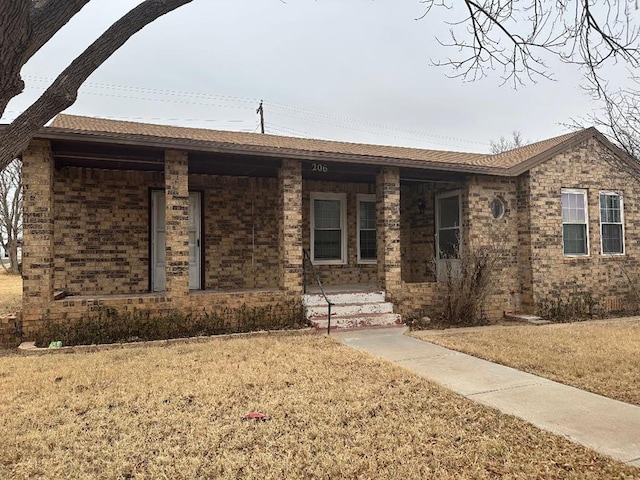 single story home with a porch and a front yard