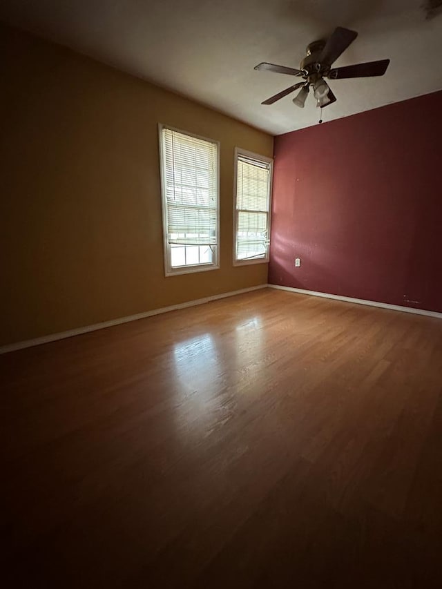 unfurnished room featuring hardwood / wood-style floors and ceiling fan