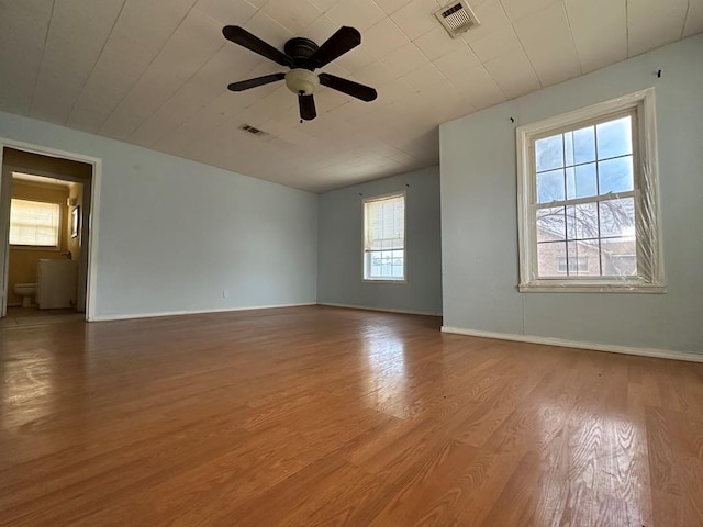 spare room featuring hardwood / wood-style flooring and ceiling fan