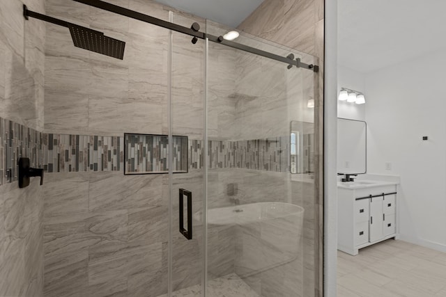 full bathroom featuring vanity, a shower stall, and baseboards