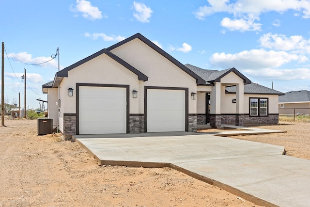 view of front facade with an attached garage, stucco siding, stone siding, and driveway