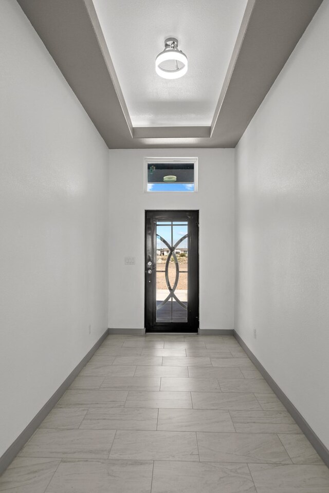 12645 W Maria Dr, Odessa, TX 79764 - foyer entrance featuring a raised ceiling and baseboards