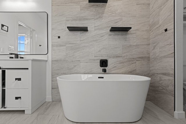 bathroom featuring a freestanding bath and vanity