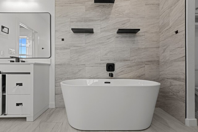 12645 W Maria Dr, Odessa, TX 79764 - bathroom featuring a freestanding bath and vanity