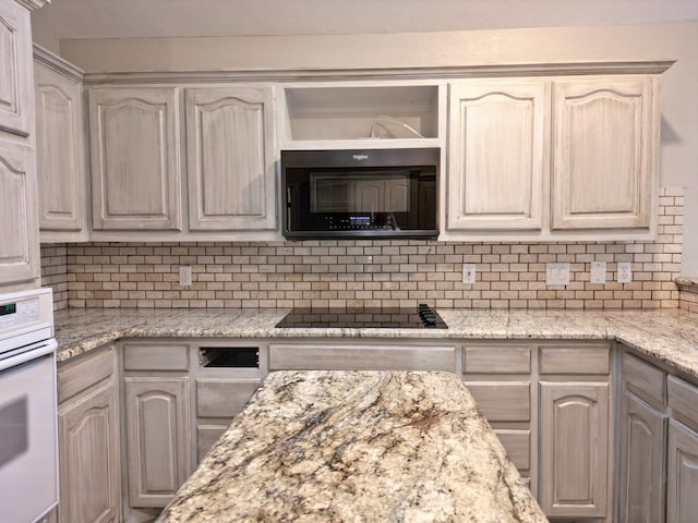 10 Lafayette Pl, Odessa, TX 79762 - kitchen featuring white oven, black electric stovetop, tasteful backsplash, and light stone counters