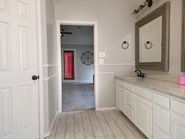 10 Lafayette Pl, Odessa, TX 79762 - bathroom featuring vanity, wood finished floors, baseboards, and ornamental molding