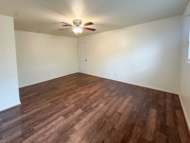 111 N 24th St, Lamesa, TX 79331 - empty room featuring ceiling fan, dark wood-style flooring, and baseboards