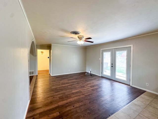 111 N 24th St, Lamesa, TX 79331 - empty room with crown molding, a ceiling fan, french doors, dark wood-type flooring, and baseboards
