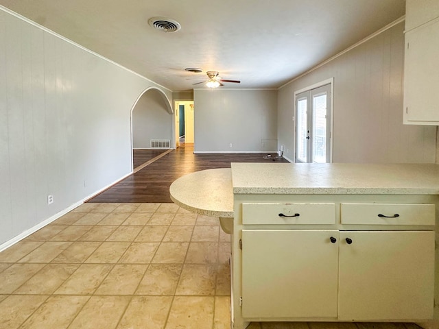 111 N 24th St, Lamesa, TX 79331 - kitchen featuring a ceiling fan, light countertops, ornamental molding, arched walkways, and baseboards