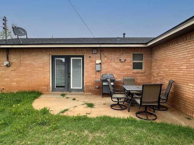 111 N 24th St, Lamesa, TX 79331 - back of property with brick siding, french doors, and a patio